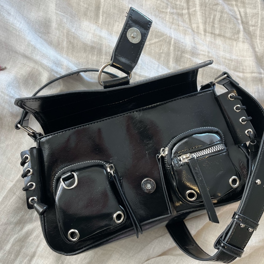 Black shoulder bag with edgy silver loops
